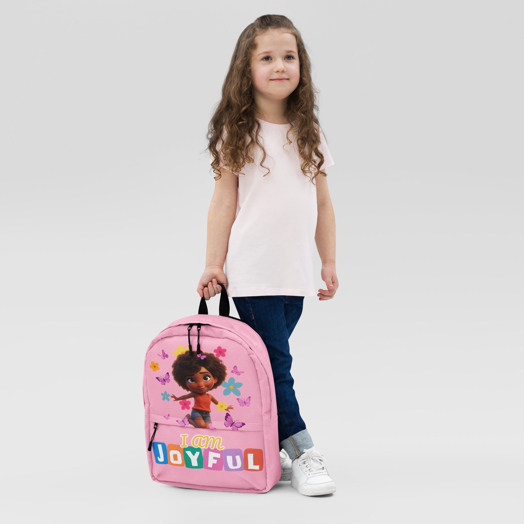 Pink backpack with all-over joyful print from Kingdom Kids Club, front view showing vibrant design and adjustable straps.