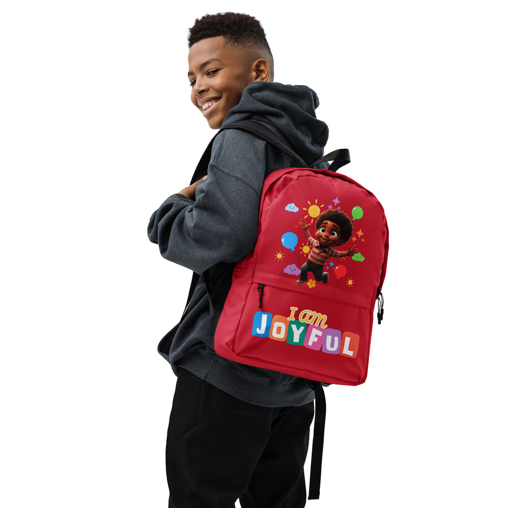 Red backpack with joyful "I Am Joyful" print by Kingdom Kids Club, all-over colorful design, shown from the right side.
